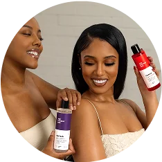 Two women holding Her Fantasy Box Refresh and Yummy body wash products.